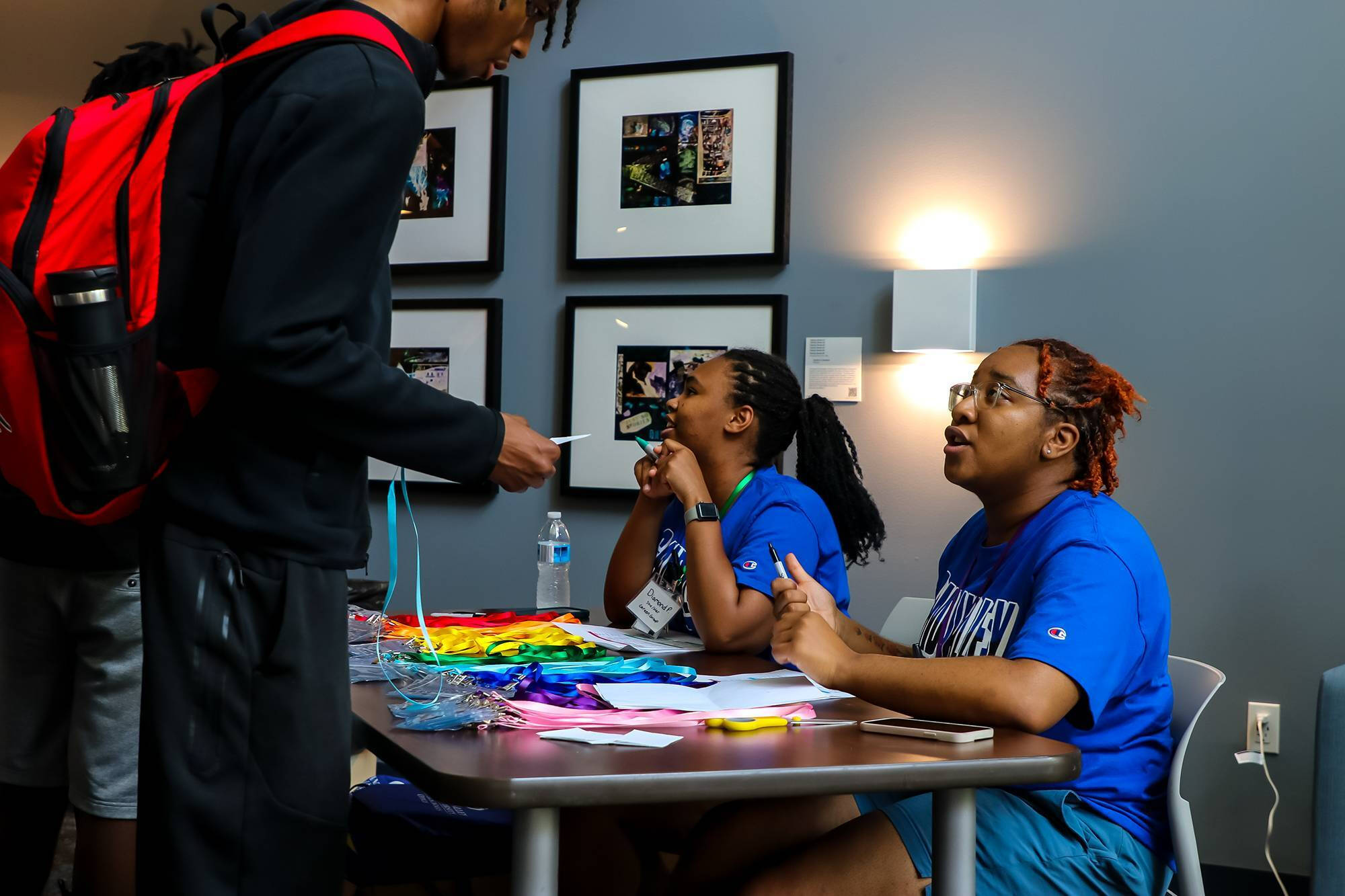 College Prep Week student checking in with camp navigators who are sitting at a desk
